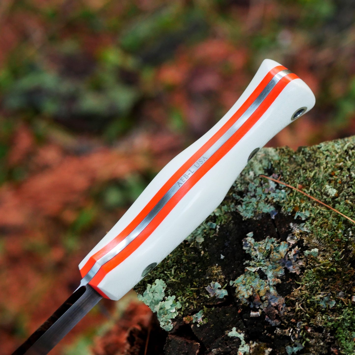 Explorer: AEB-L, White G10 with Orange G10 Liners