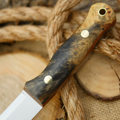 An Adventure Sworn Mountaineer bushcraft knife with Ohio buckeye burl handle scales and brown canvas liners.