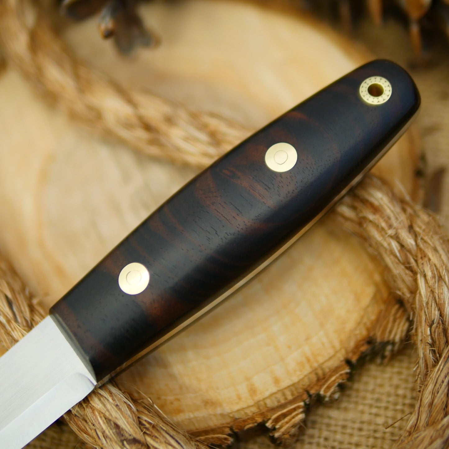 An Adventure Sworn Woodsman bushcraft knife with katalox handle scales.