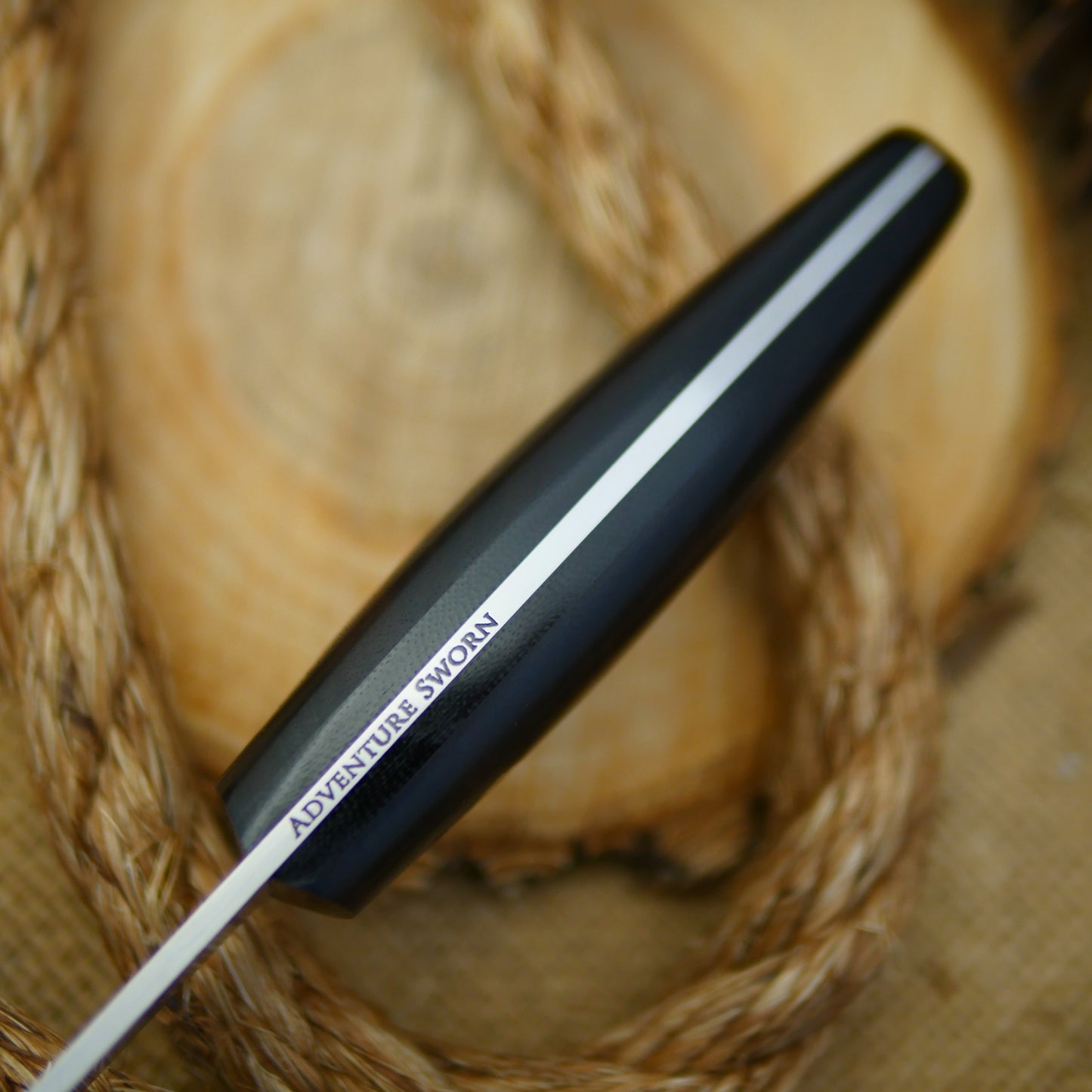 An Adventure Sworn Woodsman bushcraft knife with katalox handle scales.
