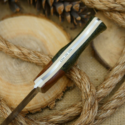 An Adventure Sworn bushcraft knife with evergreen burlap handle scales and natural brown canvas micarta bolster.