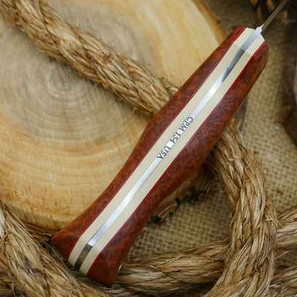 A Voyageur bushcraft knife with stabilized briar handle scales and ivory paper micarta liners