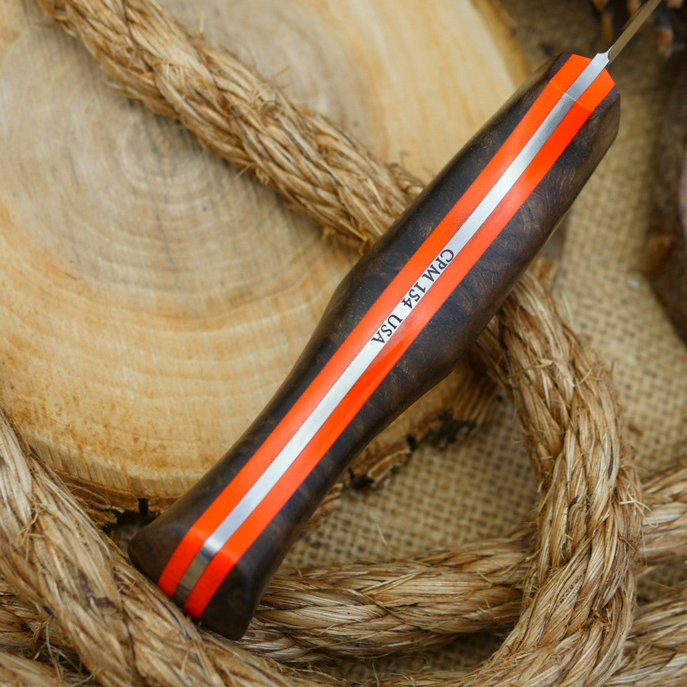 A Voyageur bushcraft knife with stabilized maple burl and hunter orange g10 liners.