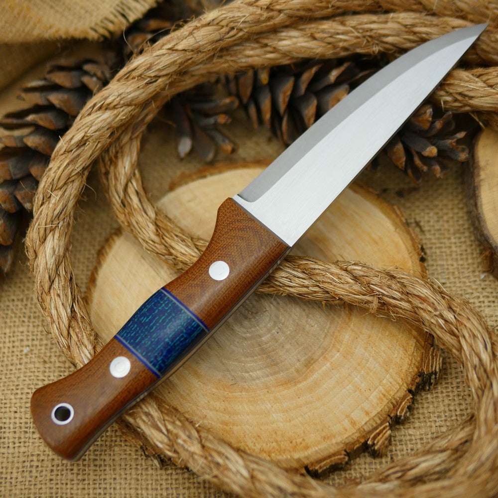 An Adventure Sworn bushcraft knife with natural brown canvas micarta handle scales and navy blue burlap spacer.