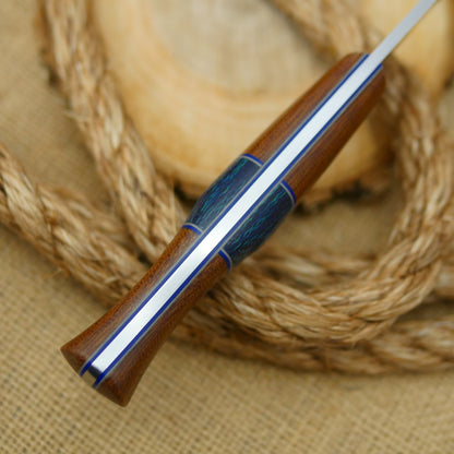 An Adventure Sworn bushcraft knife with natural brown canvas micarta handle scales and navy blue burlap spacer.